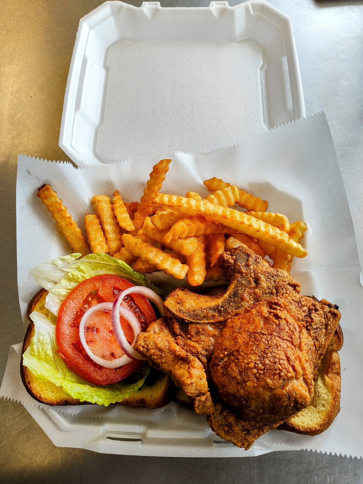 Golden fried fish plate on Texas toast with lettuce, tomato and fries